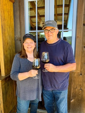 Owners Mary Roy and Bob Covert toasting wine at the tasting room